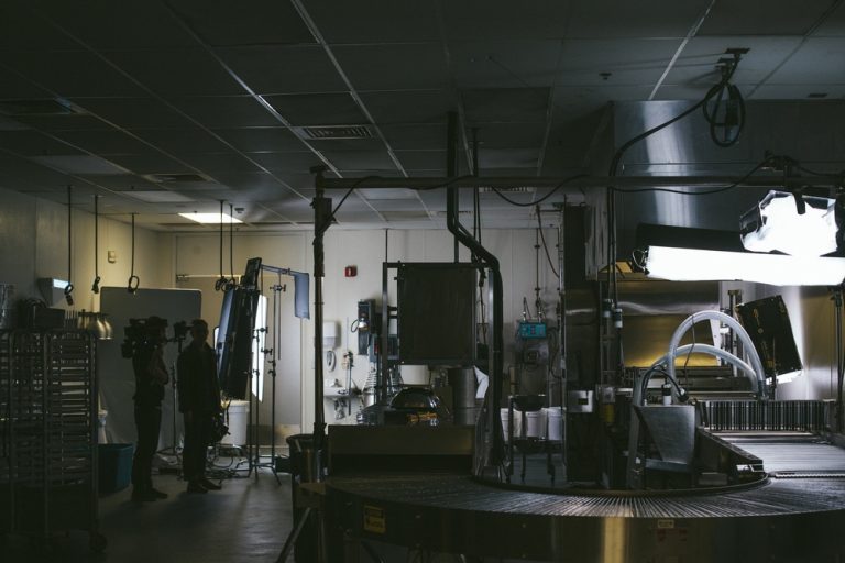 Inside Krispy Kreme’s production room, showcasing industrial equipment and lighting setup for a behind-the-scenes shoot.